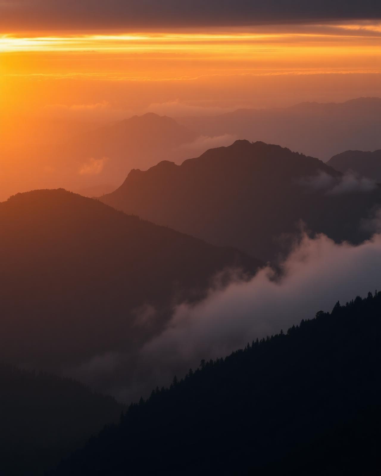 Misty mountain peaks at golden sunrise